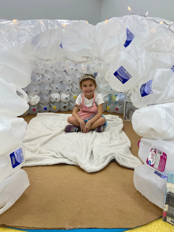 PreK reading in the QUEST Center igloo.