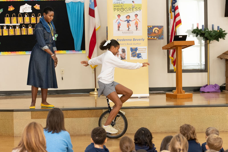 Lower School author visit - student on unicycle