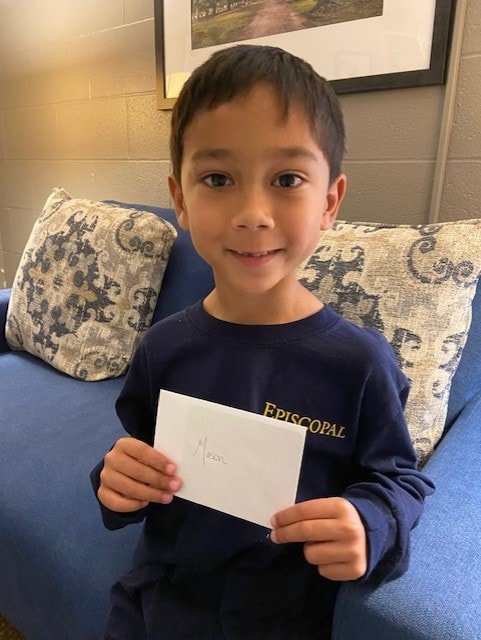 lower school student with writing assignment