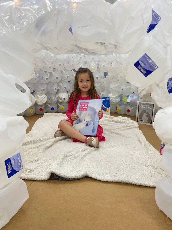 PreK reading in the QUEST Center igloo.