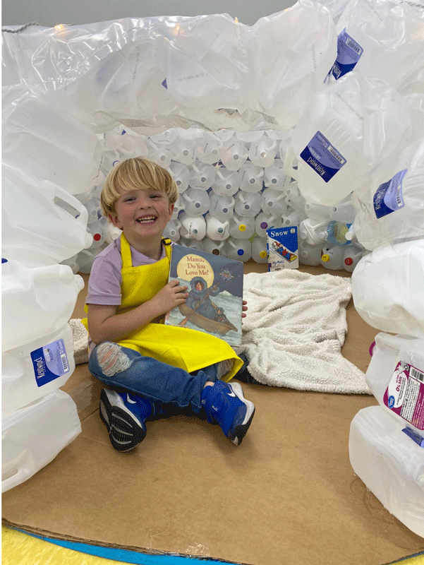 PreK reading in the QUEST Center igloo.