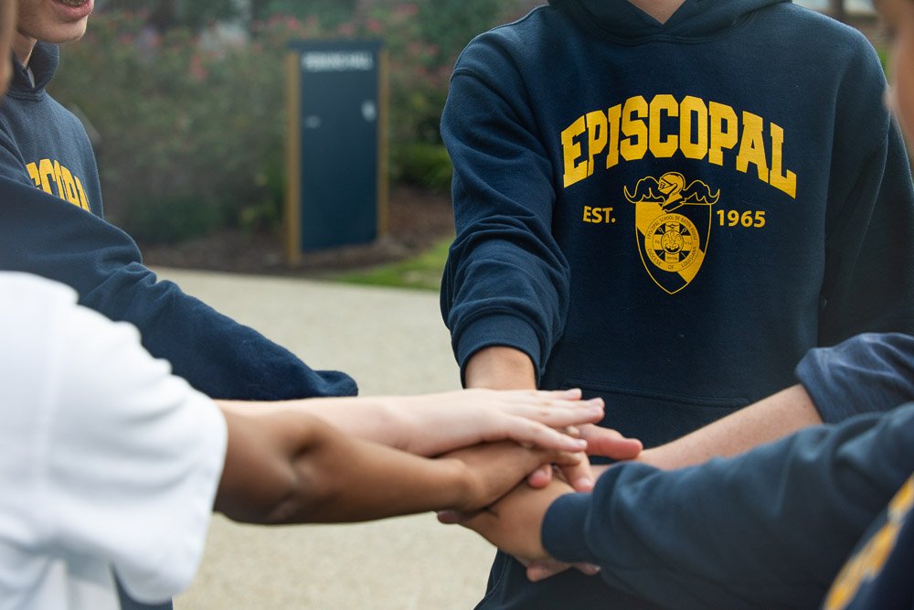 Diverse students holding hands