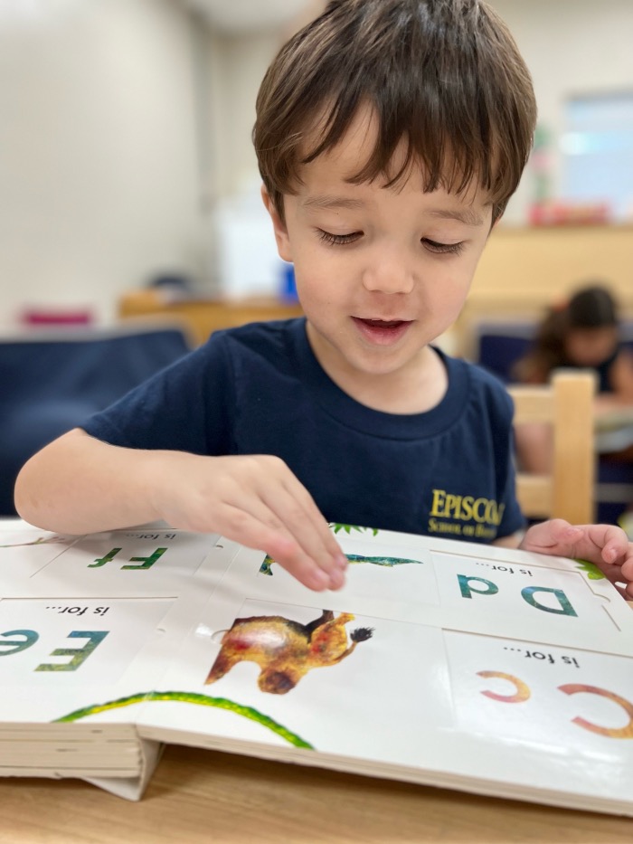 Lower School student reading a book