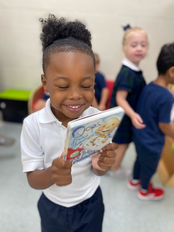 Lower School student with a book