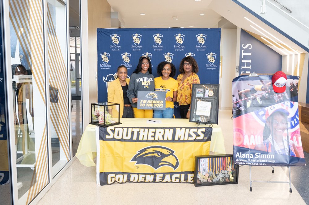 Simon signing in field house