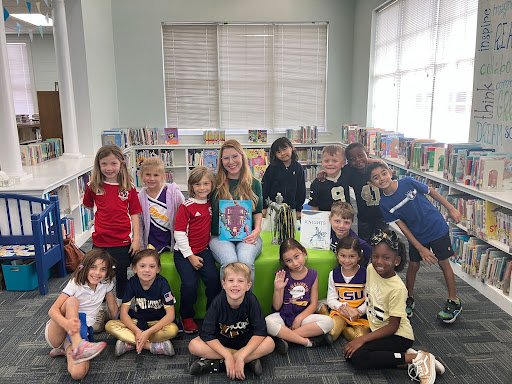 Alumni reading to Lower School students