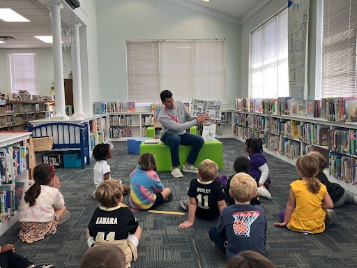 Alumni reading to Lower School students