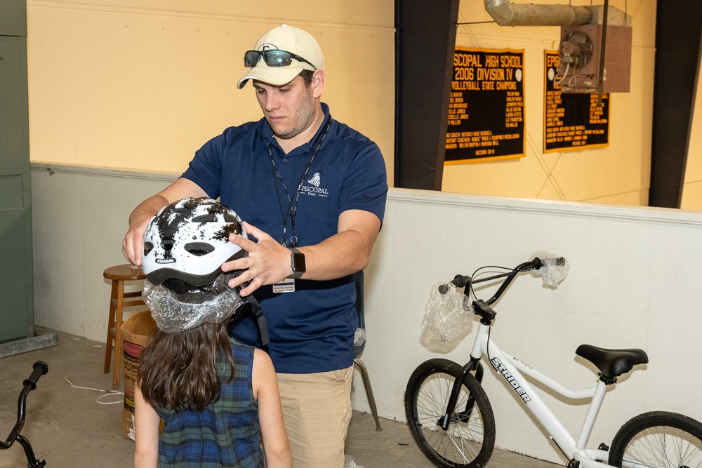 Coach Martin helping with helmets