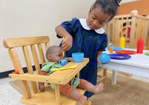 Early childhood student with doll