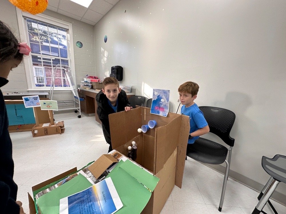 Students at cardboard arcade