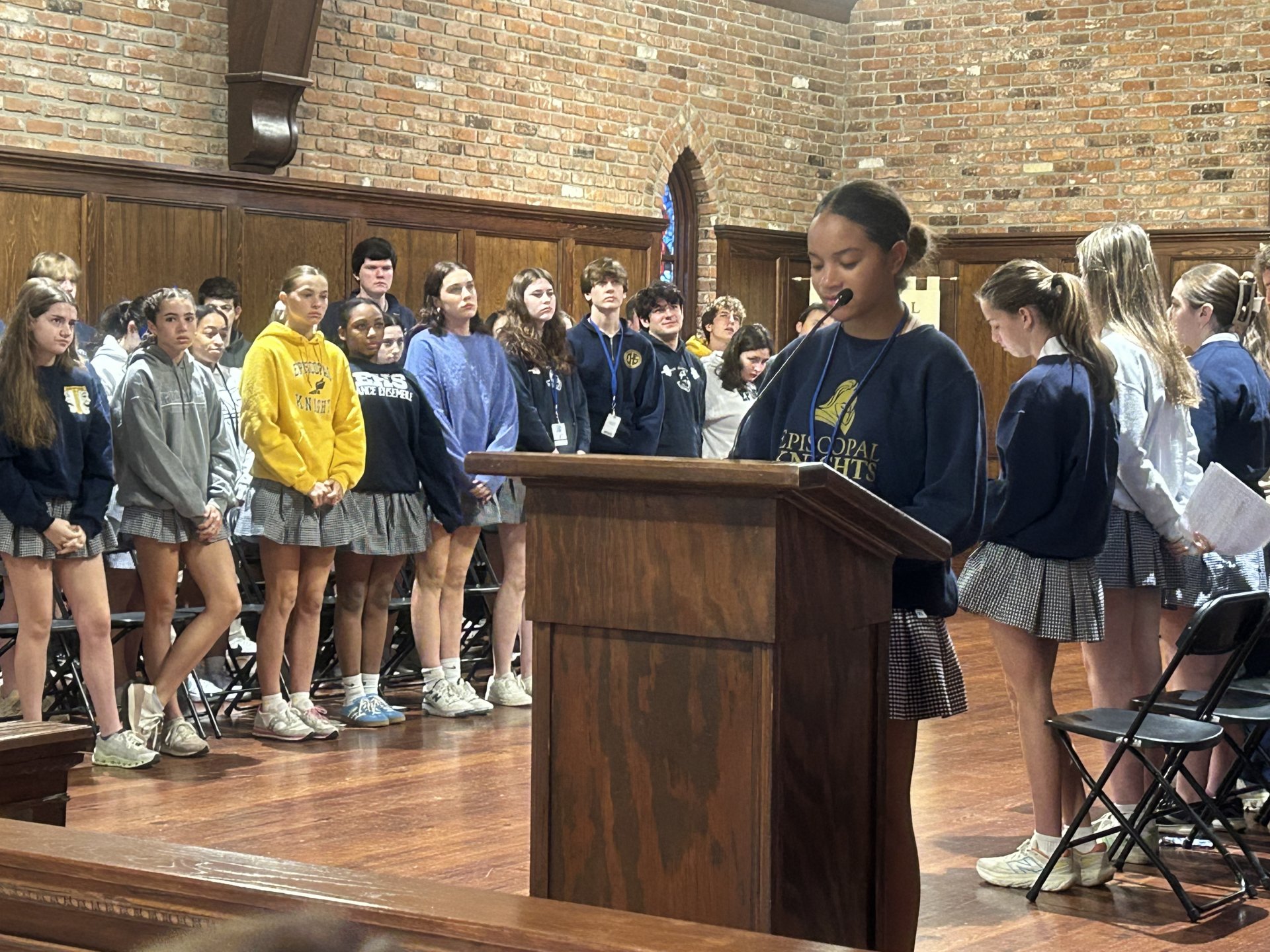 Student offering prayers in chapel