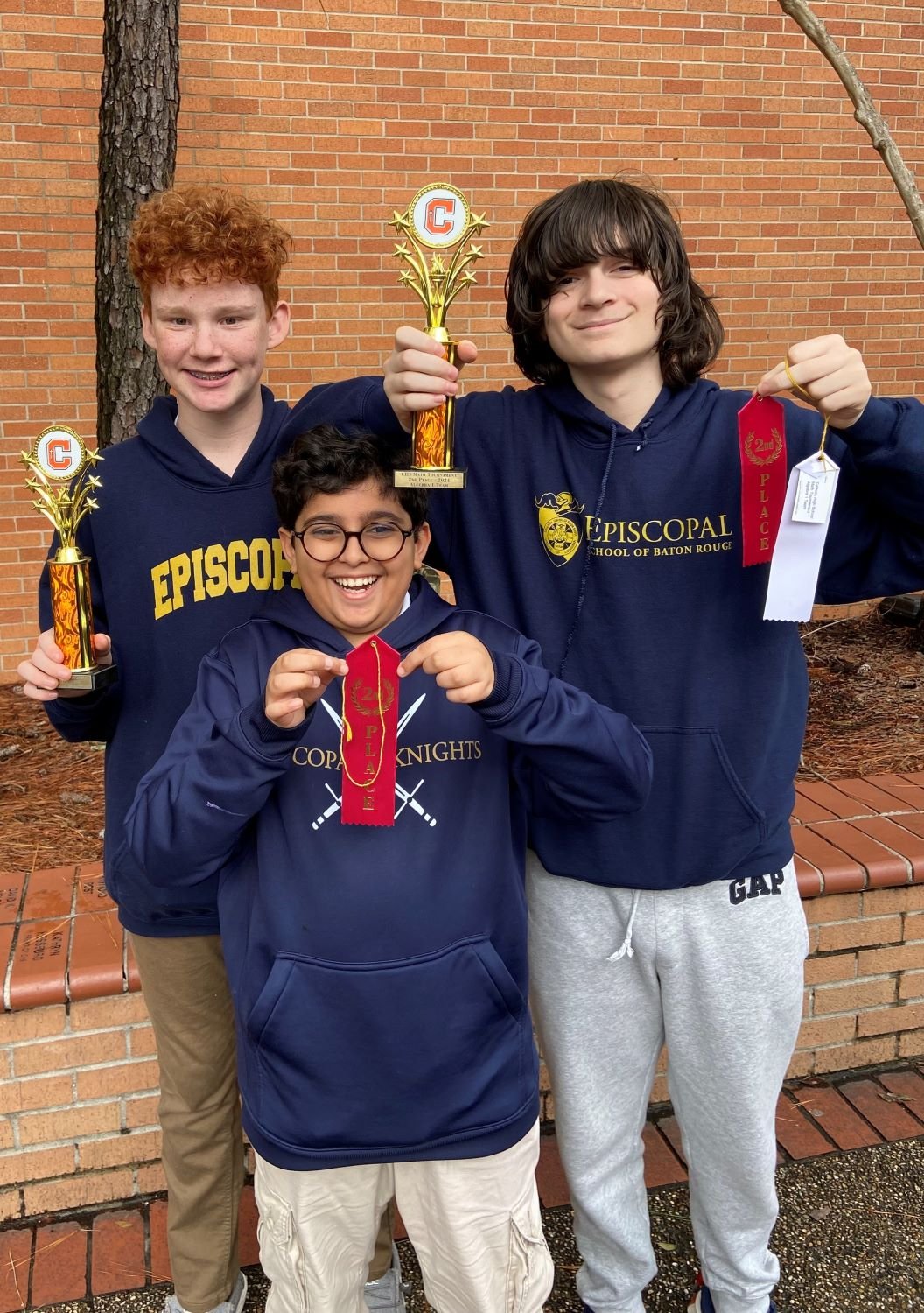 Mu Alpha Theta students with ribbons and trophies