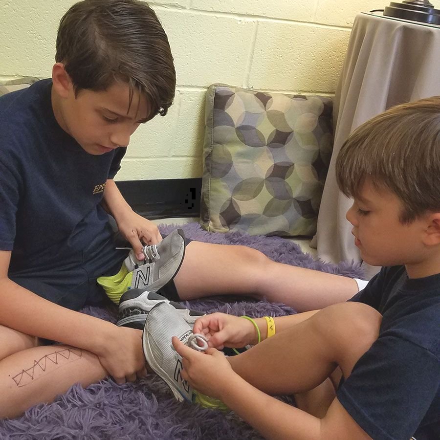 Students tying their shoes