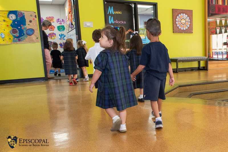 PreK-3 students walking hand in hand