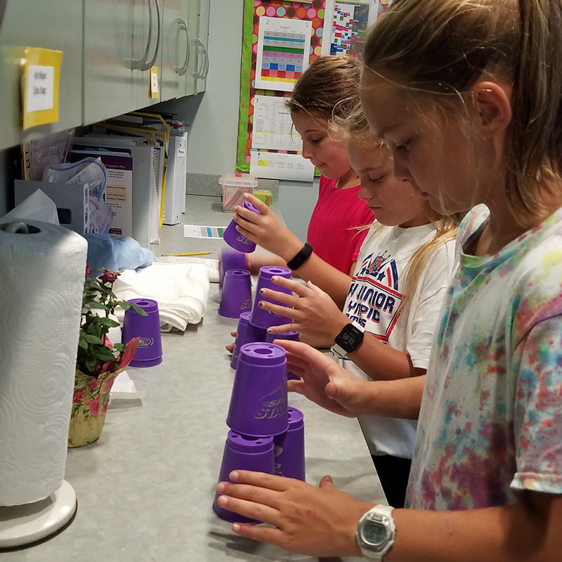 Students play the cup game.