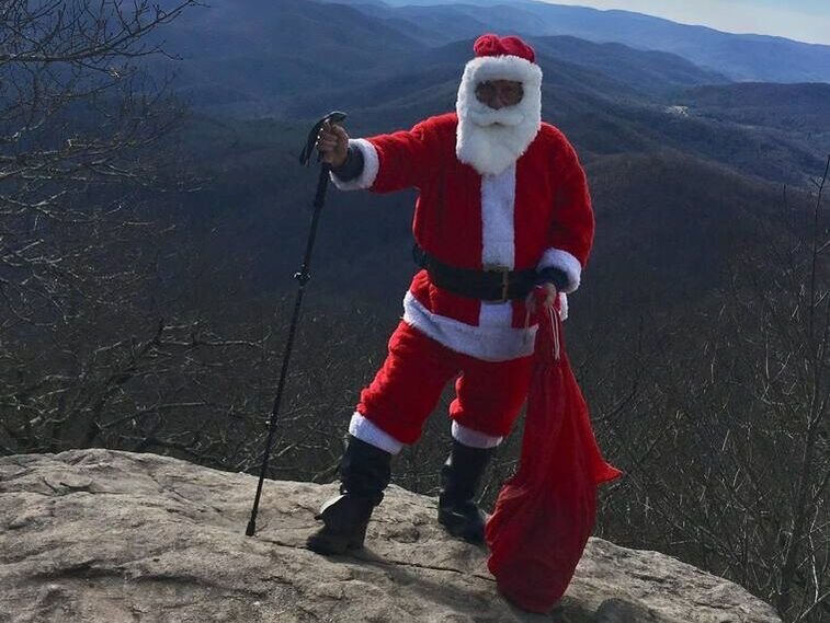 Coach Cole hiking as Santa