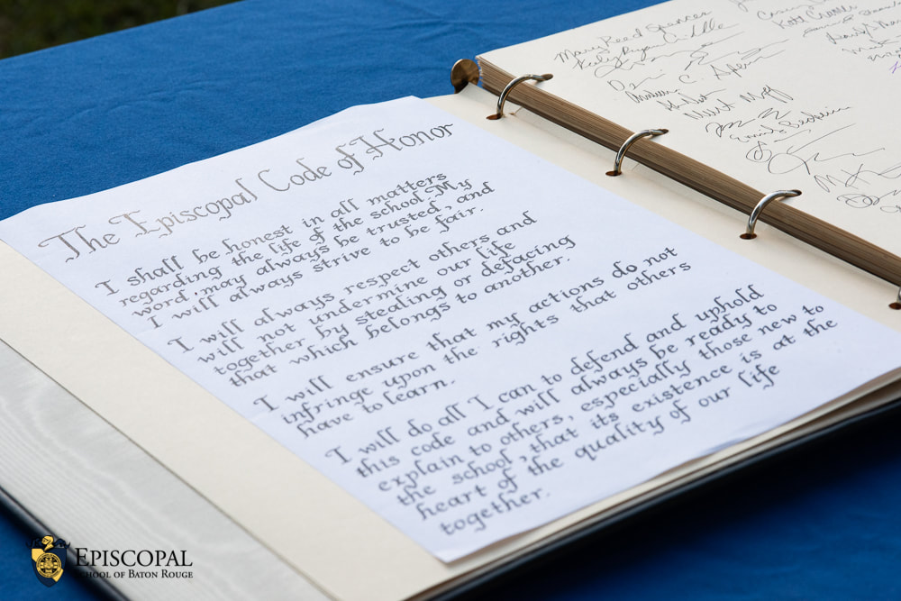 Open binder displaying the Episcopal Code of Honor and signature sheet Handwritten 'Episcopal Code of Honor' pledge page in a three-ring binder with a facing page of signatures and the Episcopal School of Baton Rouge logo