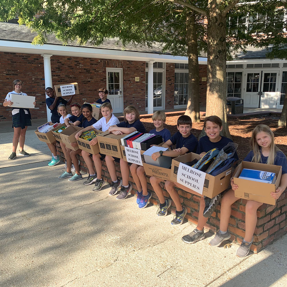 Students bring donations to Melrose Elementary.