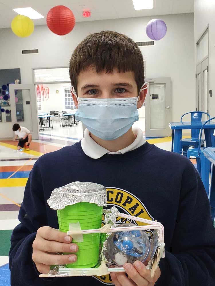 student holding cup robot