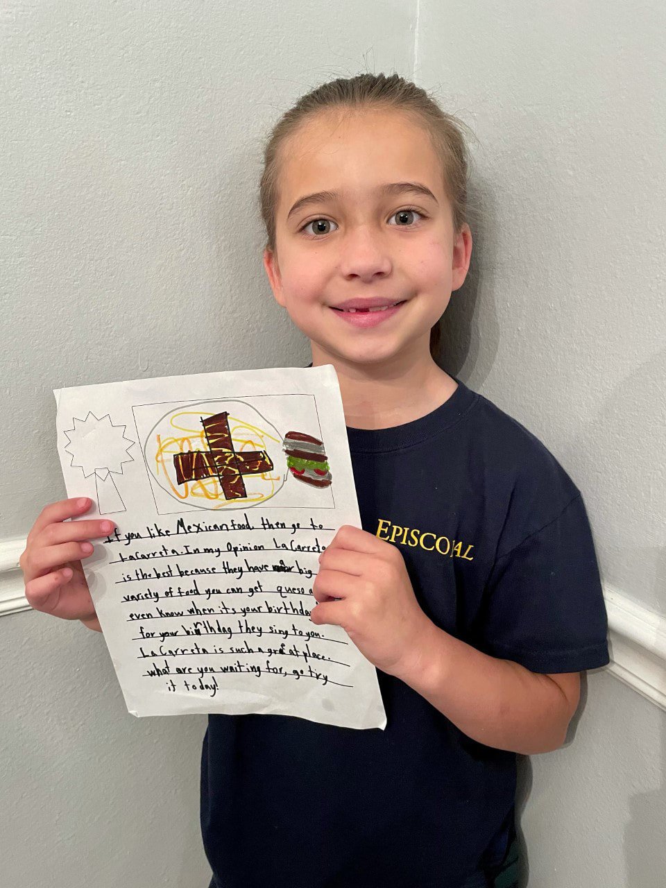 lower school student with writing assignment