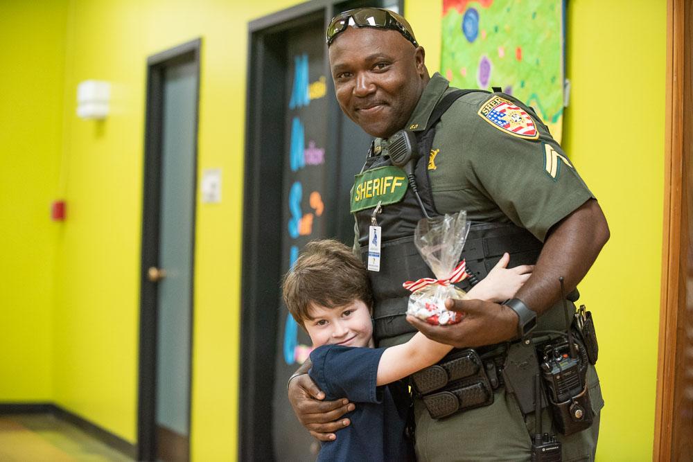 Police Officer with a Young Boy at School