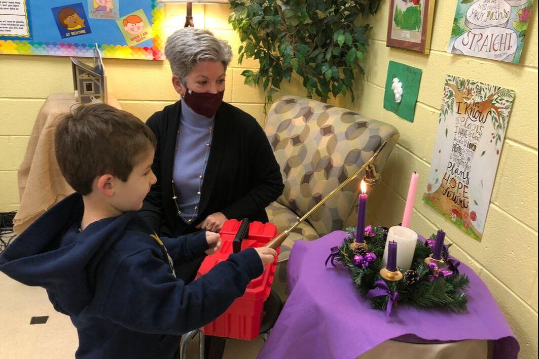 Student lighting candle